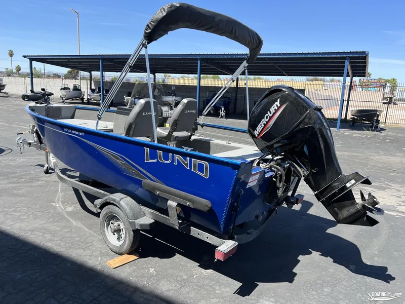 Slide: The Image of 2022 Lund 1650 Angler SS boat with Mercury outboard motor, parked on a trailer. - 3