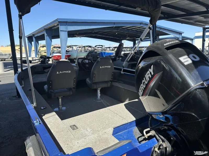 Slide: The Image of 2022 Lund 1650 Angler SS boat with Mercury 50 engine in marina setting. - 4