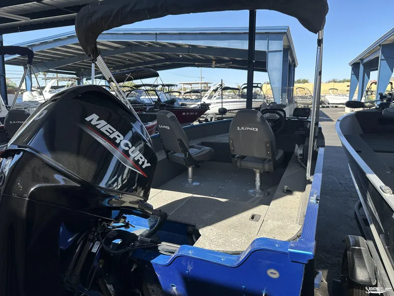 Slide: The Image of 2022 Lund 1650 Angler SS boat with Mercury engine in a marina setting. - 6