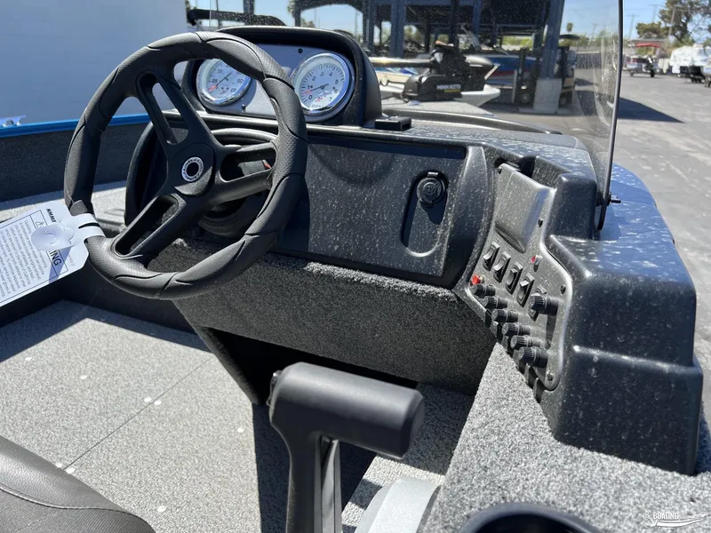 Slide: The Image of 2022 Lund 1650 Angler SS boat dashboard with steering wheel and control panel. - 9