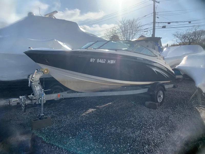 The Image of 2012 Yamaha Boats SX190 on trailer, black hull, outdoor storage. - 0