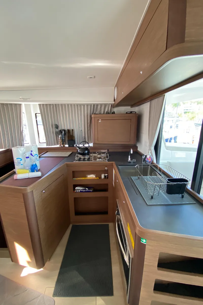 Slide: The Image of Modern kitchen interior of 2022 Lagoon 42 catamaran with sleek wood finish. - 10