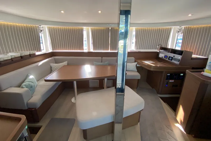 Slide: The Image of Interior of 2022 Lagoon 42 catamaran with modern seating and navigation area. - 11