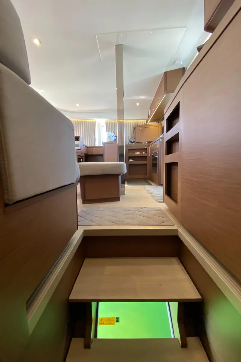 Slide: The Image of Interior view of 2022 Lagoon 42 catamaran, featuring modern wooden design and comfortable seating. - 12