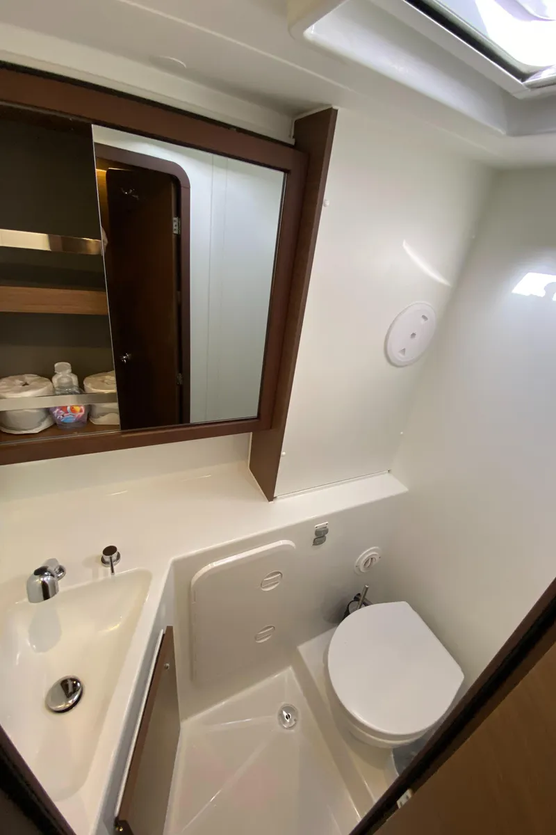 Slide: The Image of Modern bathroom in 2022 Lagoon 42 yacht with sink, toilet, and mirror. - 16