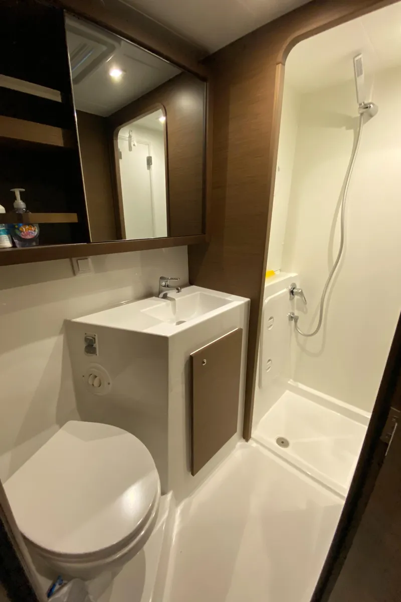 Slide: The Image of Modern bathroom in 2022 Lagoon 42 yacht with shower, sink, and toilet. - 19
