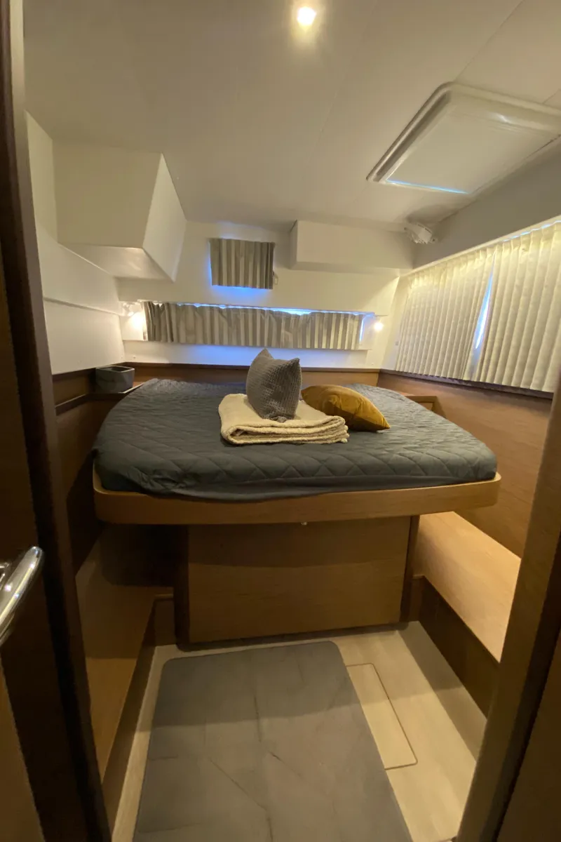 Slide: The Image of 2022 Lagoon 42 yacht cabin with cozy bed and modern interior design. - 21