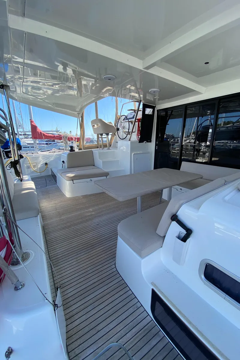 Slide: The Image of Spacious deck of 2022 Lagoon 42 catamaran with seating and table. - 7