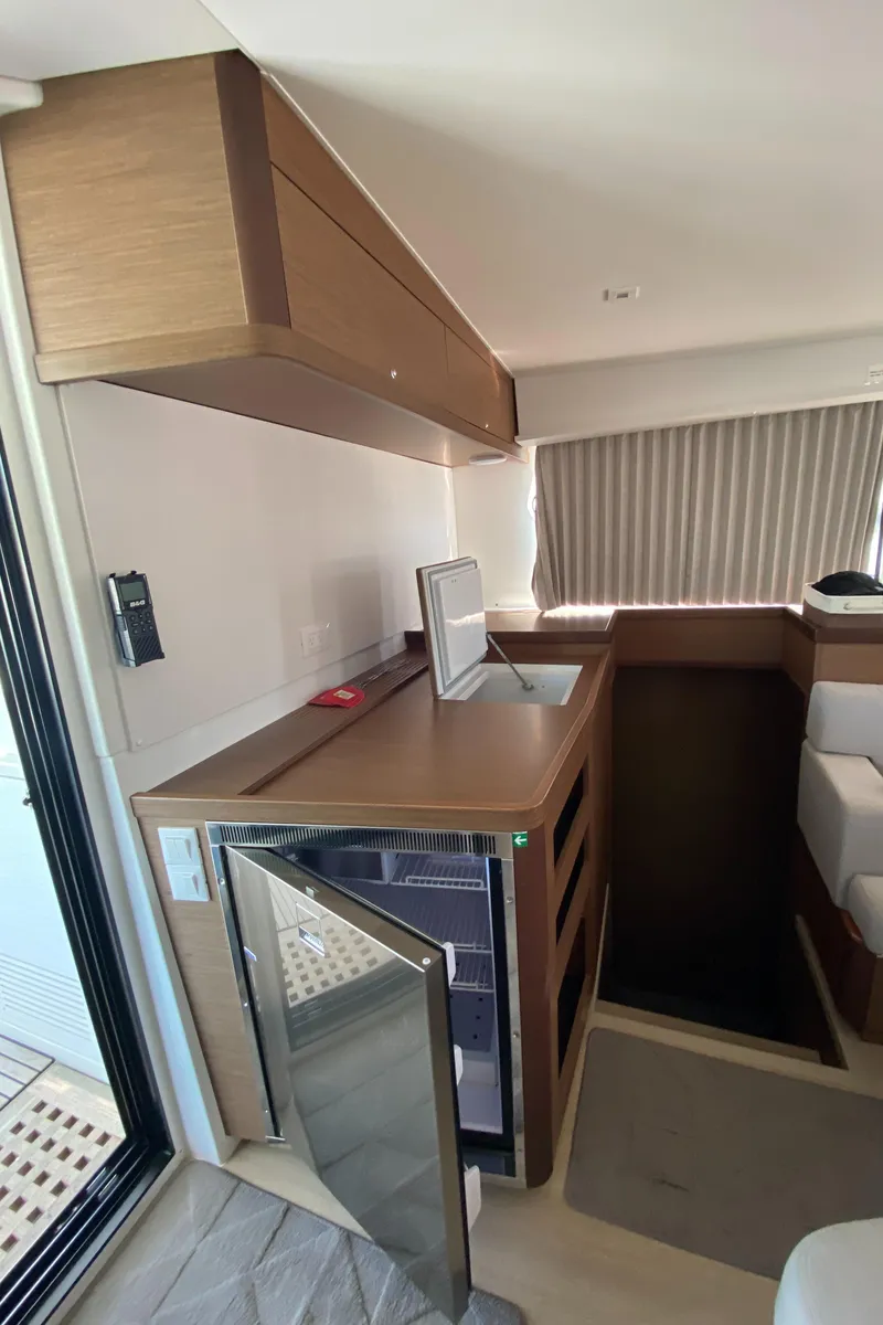 Slide: The Image of Interior of 2022 Lagoon 42 yacht with modern kitchenette and compact fridge. - 8
