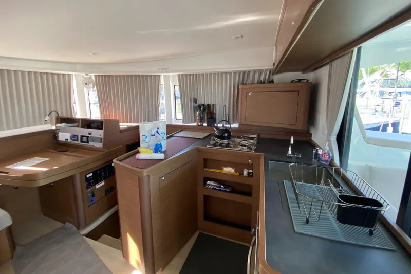 Slide: The Image of Interior of 2022 Lagoon 42 yacht featuring modern kitchen and dining area. - 9