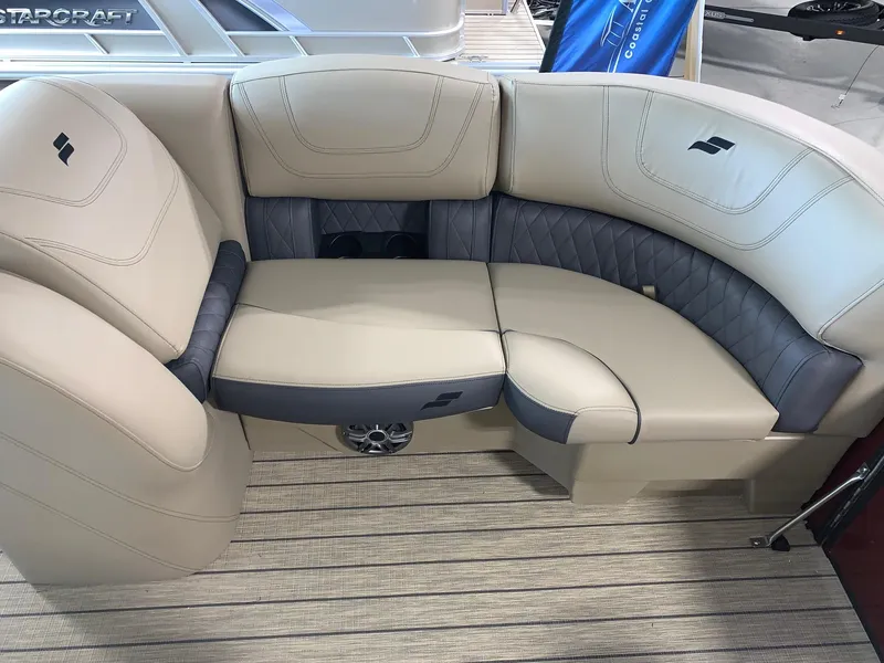 Slide: The Image of 2024 Starcraft SLS 3 Q DH boat interior seating with beige and gray upholstery. - 10