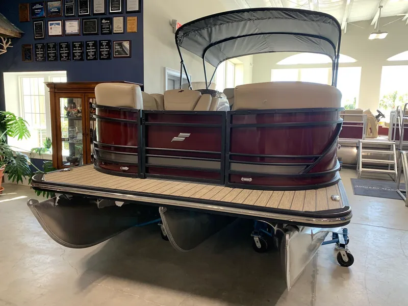 Slide: The Image of 2024 Starcraft SLS 3 Q DH pontoon boat in showroom. - 2