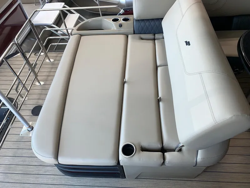 Slide: The Image of 2024 Starcraft SLS 3 Q DH boat interior with beige seating and cup holders. - 3