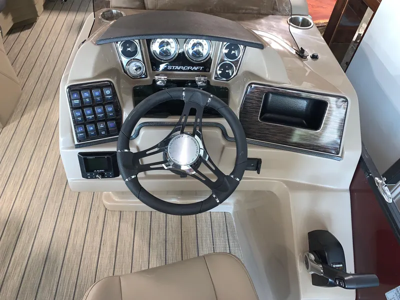 Slide: The Image of 2024 Starcraft SLS 3 Q DH boat dashboard with steering wheel and control panel. - 7