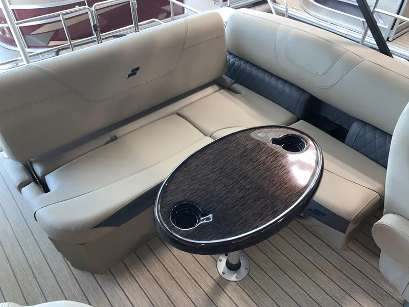 Slide: The Image of 2024 Starcraft SLS 3 Q DH boat interior with beige seating and oval table. - 14