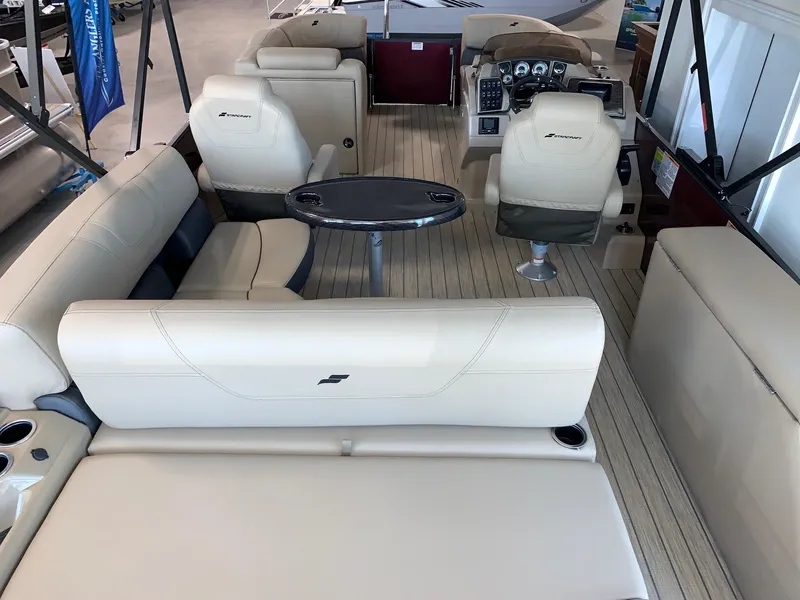Slide: The Image of 2024 Starcraft SLS 3 Q DH pontoon boat interior with beige seating and modern dashboard. - 5
