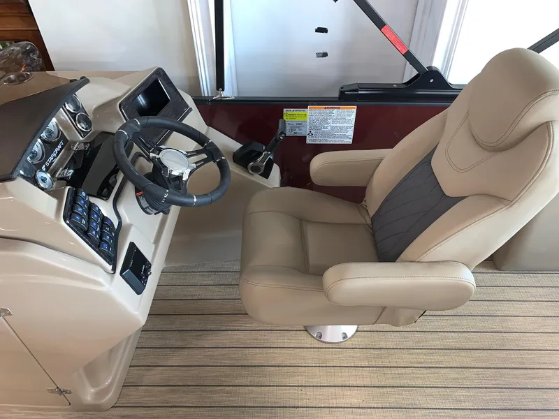 Slide: The Image of 2024 Starcraft SLS 3 Q DH boat helm with captain's chair and control panel. - 8