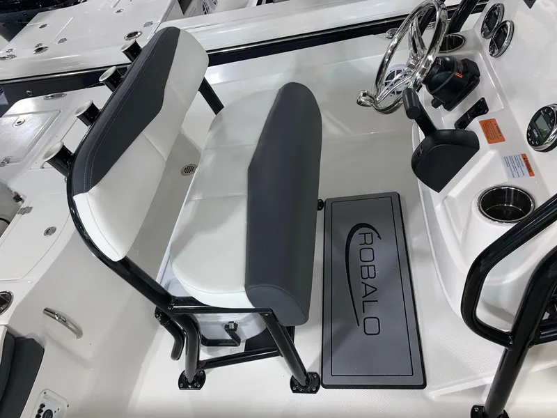 Slide: The Image of 2024 Robalo 206 Cayman boat interior with dual seats and steering console. - 6