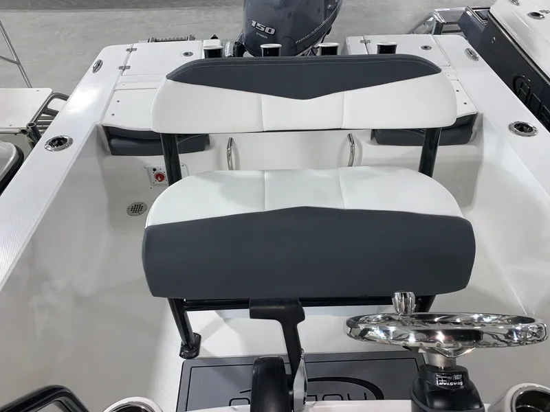 Slide: The Image of 2024 Robalo 206 Cayman boat interior with dual seating and steering wheel. - 7