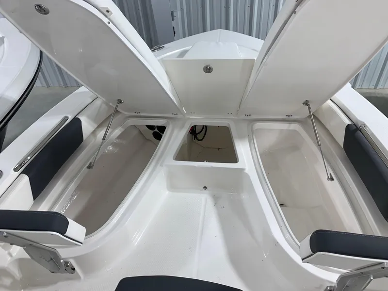 Slide: The Image of 2024 Robalo 206 Cayman boat with open storage compartments. - 9