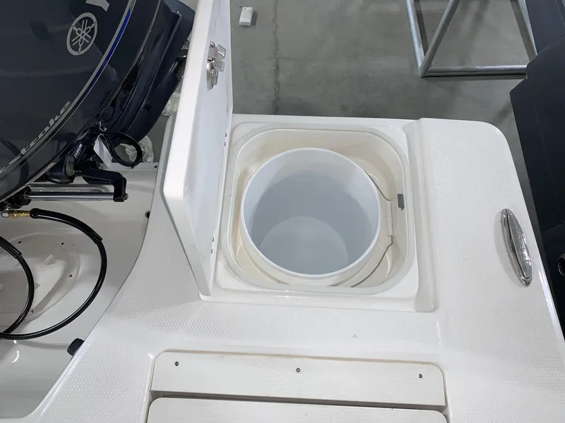 Slide: The Image of 2024 Robalo 206 Cayman livewell compartment with open lid. - 12