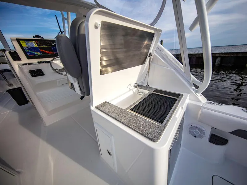 Slide: The Image of 2025 Albemarle 31DC boat interior with helm station and sink. - 16