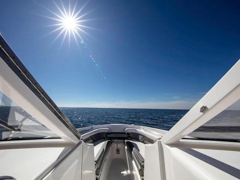 Slide: The Image of 2025 Albemarle 31DC boat on open water under bright sun. - 24