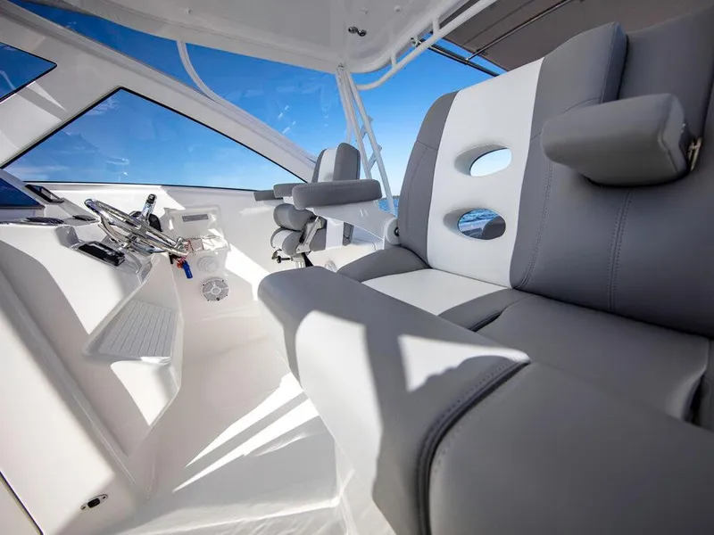 Slide: The Image of 2025 Albemarle 31DC boat interior with modern seating and steering wheel. - 28