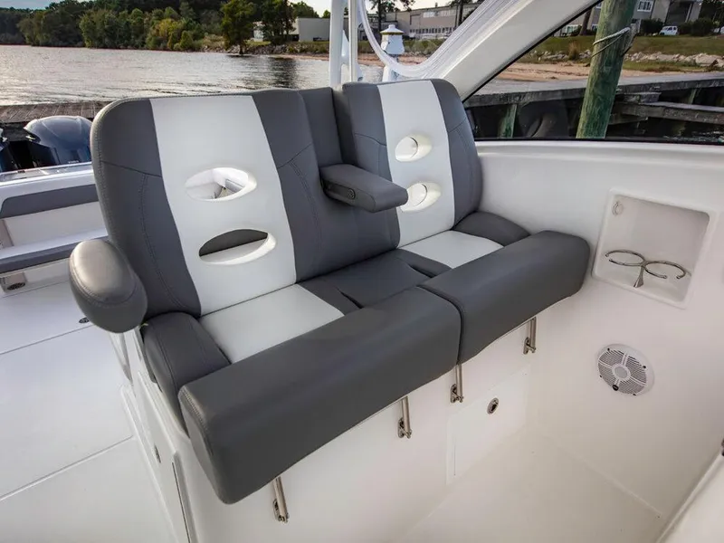 Slide: The Image of 2025 Albemarle 31DC boat interior seating with cup holders and armrest. - 30