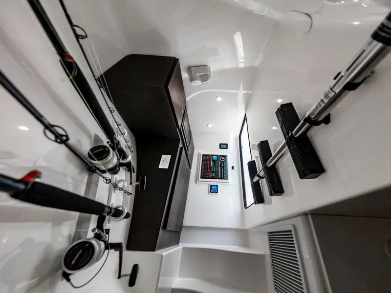 Slide: The Image of Interior of 2025 Albemarle 31DC boat with fishing rods and control panel. - 32