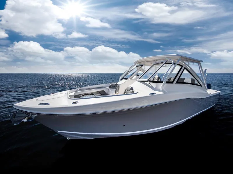 Slide: The Image of 2025 Albemarle 31DC boat on open water under a sunny sky. - 4