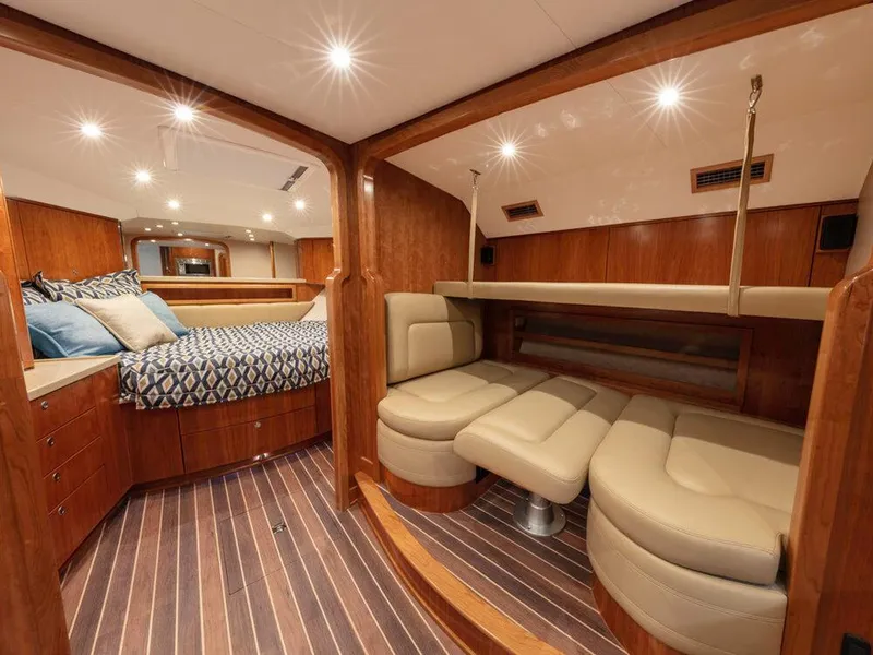 Slide: The Image of Luxurious interior of 2025 Albemarle 410 Express Fisherman yacht with wood finishes and cozy seating. - 11