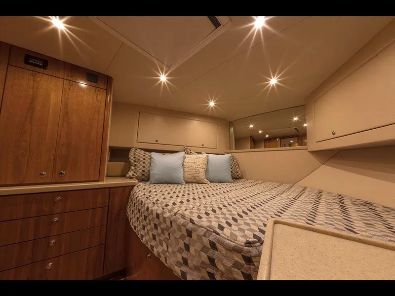 Slide: The Image of 2025 Albemarle 410 Express Fisherman cabin with bed and wooden cabinetry. - 14