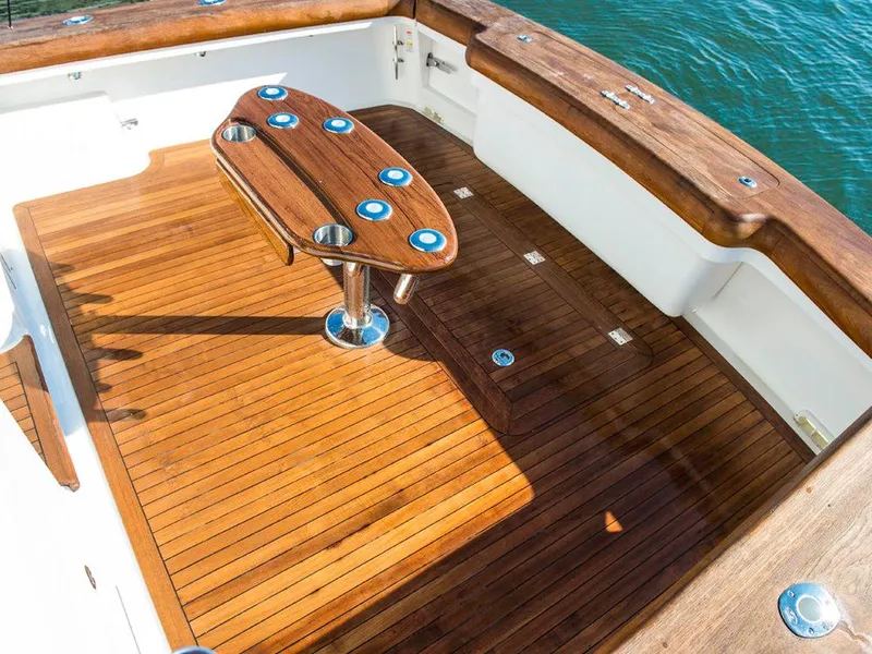 Slide: The Image of 2025 Albemarle 410 Express Fisherman boat deck with wooden flooring and fishing table. - 18