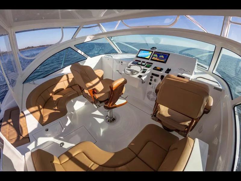 Slide: The Image of 2025 Albemarle 410 Express Fisherman cockpit with modern navigation equipment and luxurious seating. - 21