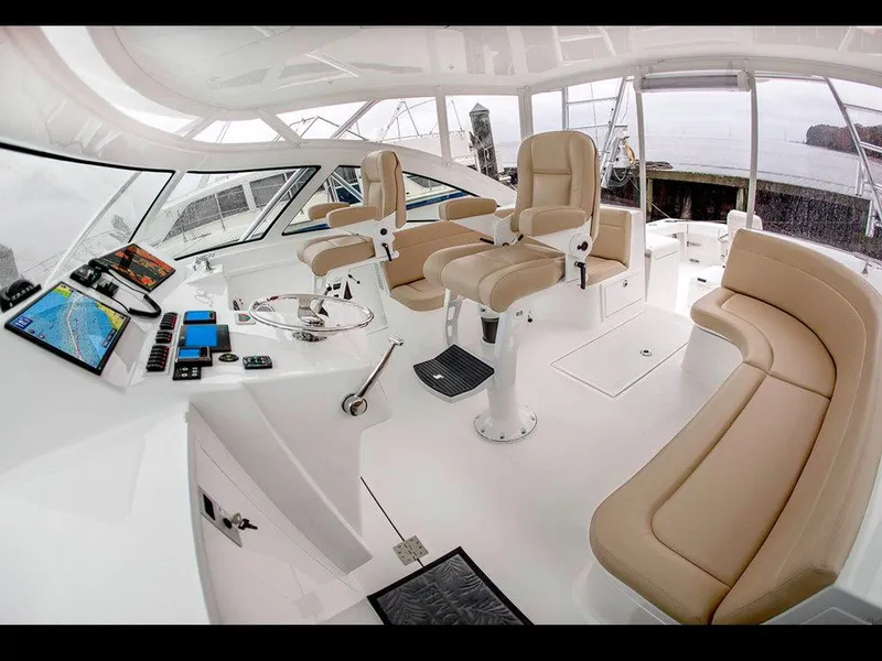 Slide: The Image of 2025 Albemarle 410 Express Fisherman helm with modern controls and beige seating. - 23