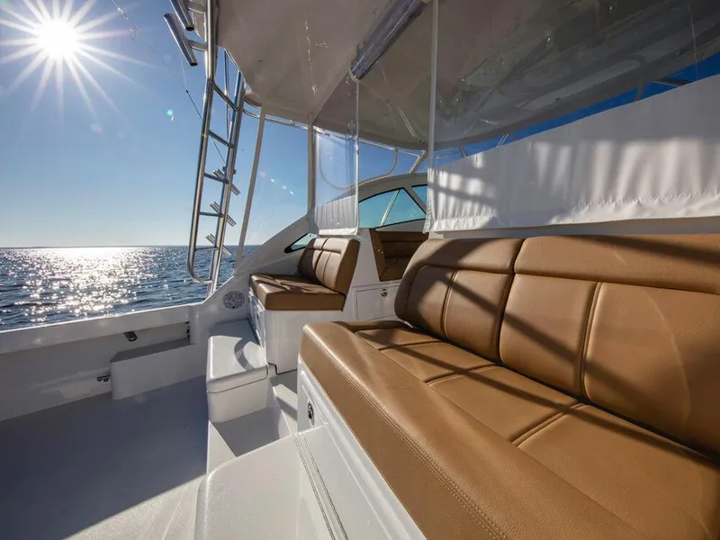 Slide: The Image of 2025 Albemarle 410 Express Fisherman boat interior with tan leather seating. - 31
