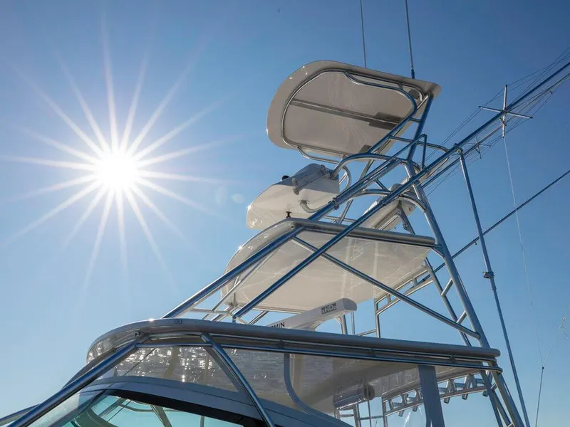 Slide: The Image of 2025 Albemarle 410 Express Fisherman boat tower under bright sun. - 34