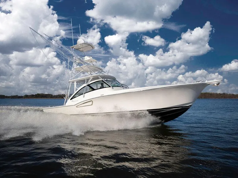 Slide: The Image of 2025 Albemarle 410 Express Fisherman cruising on water under a partly cloudy sky. - 36