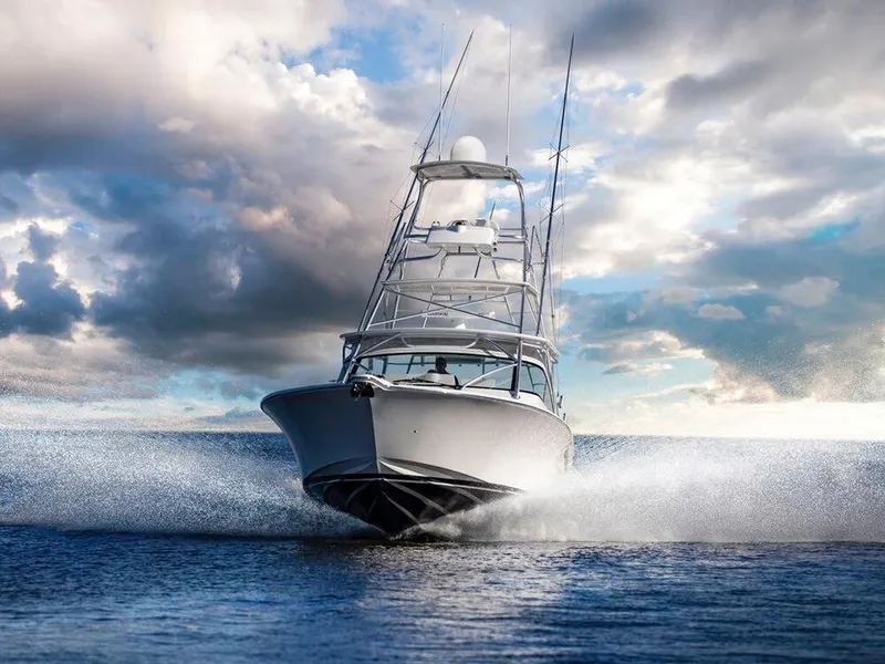 Slide: The Image of 2025 Albemarle 410 Express Fisherman boat cruising on water under dramatic sky. - 4