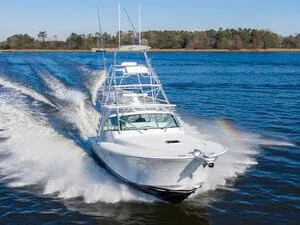 Slide: The Image of 2025 Albemarle 410 Express Fisherman cruising on a lake. - 5