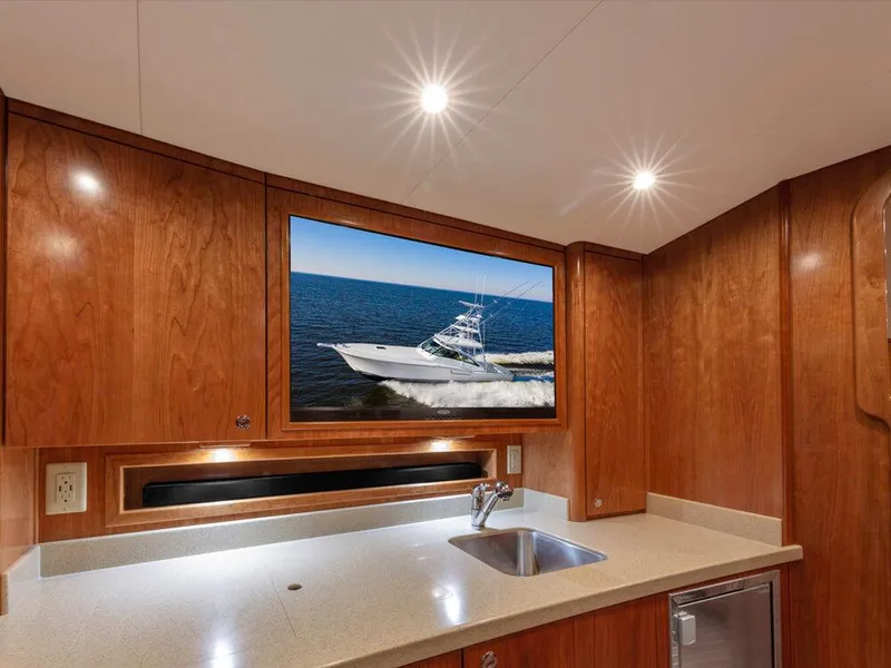 Slide: The Image of Interior of 2025 Albemarle 410 Express Fisherman with wooden cabinetry and modern sink. - 8