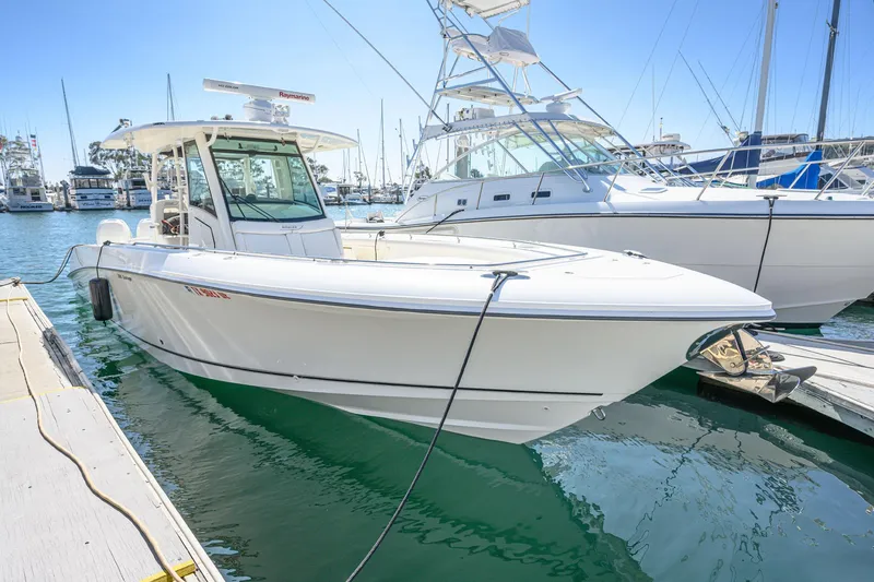 Slide: The Image of 2016 Boston Whaler 350 Outrage boat docked in harbor. - 11