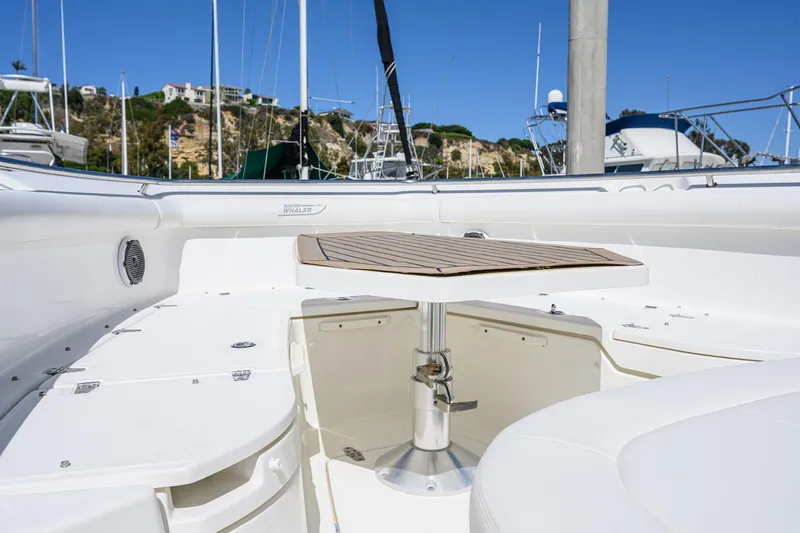 Slide: The Image of 2016 Boston Whaler 350 Outrage with deck table in harbor. - 26