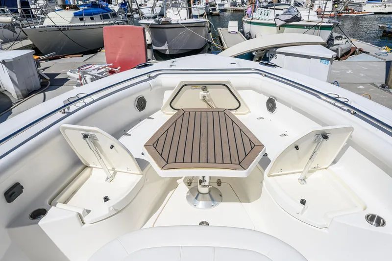 Slide: The Image of 2016 Boston Whaler 350 Outrage with spacious deck and wooden table. - 30