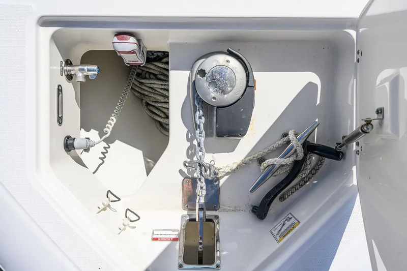 Slide: The Image of Anchor compartment of 2016 Boston Whaler 350 Outrage with chain and rope. - 32