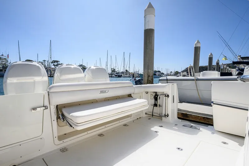 Slide: The Image of 2016 Boston Whaler 350 Outrage at dock, empty seating area visible. - 37