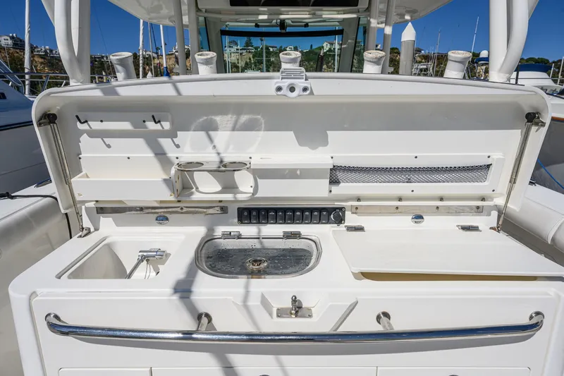 Slide: The Image of 2016 Boston Whaler 350 Outrage boat kitchen with sink and storage. - 40