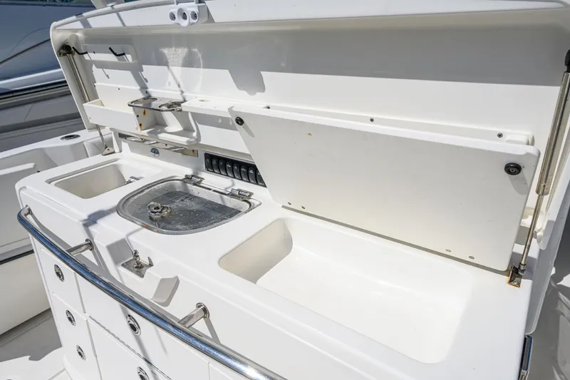 Slide: The Image of 2016 Boston Whaler 350 Outrage boat kitchen with sink and storage. - 42