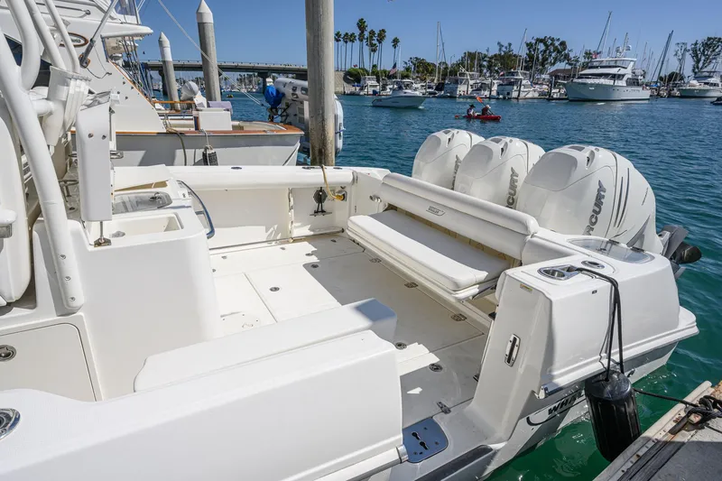 Slide: The Image of 2016 Boston Whaler 350 Outrage docked, featuring triple outboard engines. - 45